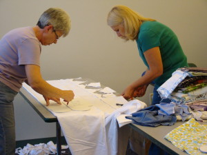 Volunteers Donna Gaynor and Becky diesel as they cut out the pieces for sleepers.
