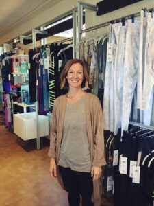Kari Touhey, boutique manager at Dynamic Body, exhibits yoga accessories.